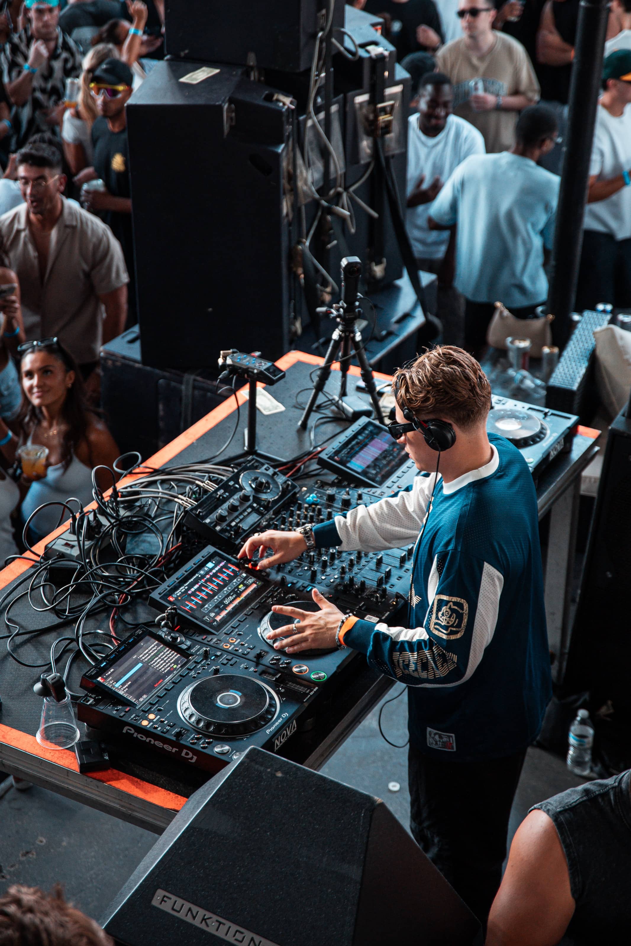 Overhead view of the DJ working Nova's Pioneer rig above the crowd
